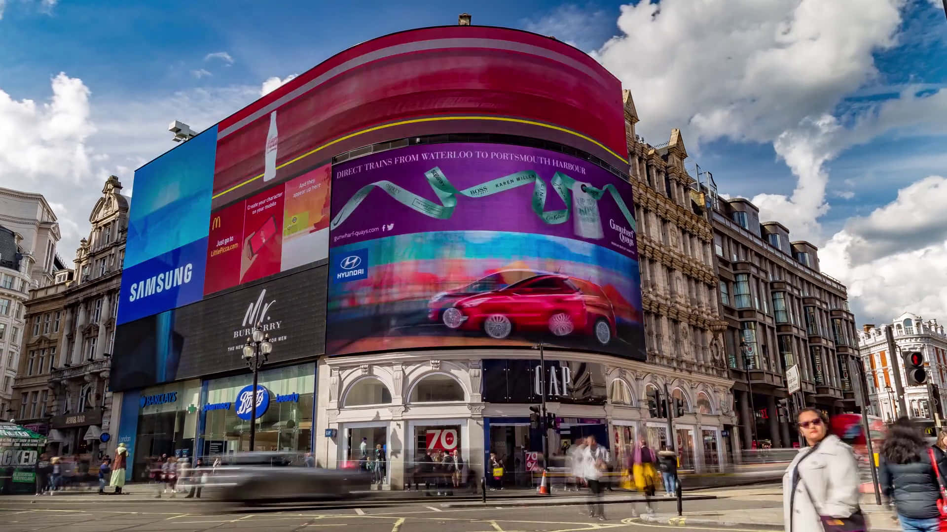 Piccadilly Circus neon and West End crowds at dusk